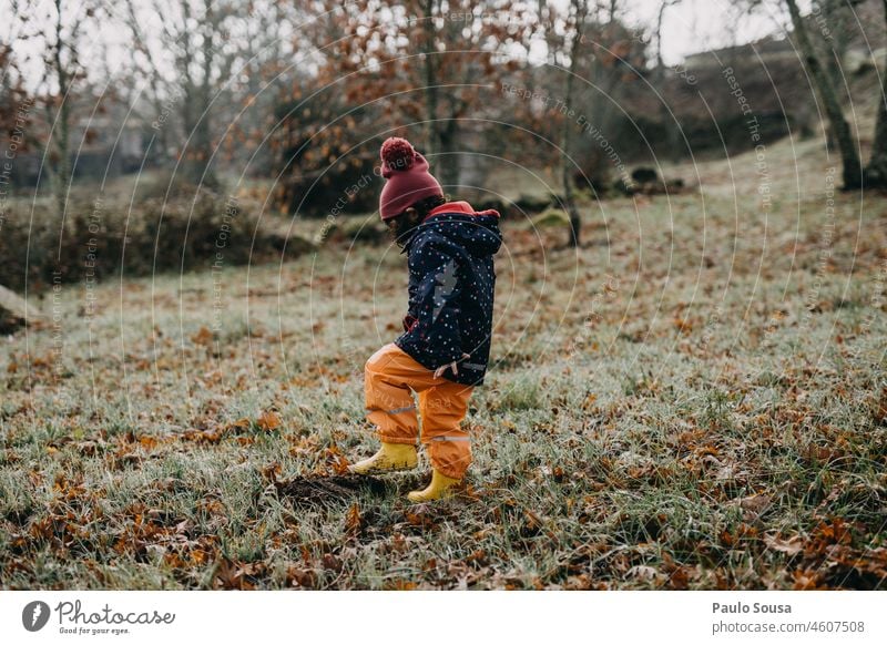 Child playing outdoors Girl one person 3 - 8 years childhood Winter Rubber boots Infancy Human being Colour photo Exterior shot Playing Joy Day Happiness 1