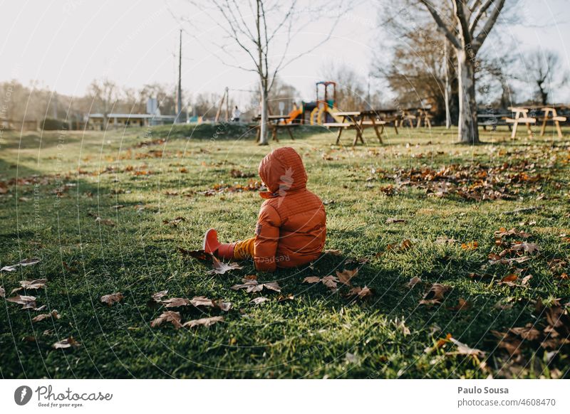 Rear view child sitting on grass Child Grass Hooded (clothing) Hooded jacket tantrum Whining Hooded sweater Autumn Colour photo Human being Jacket Exterior shot
