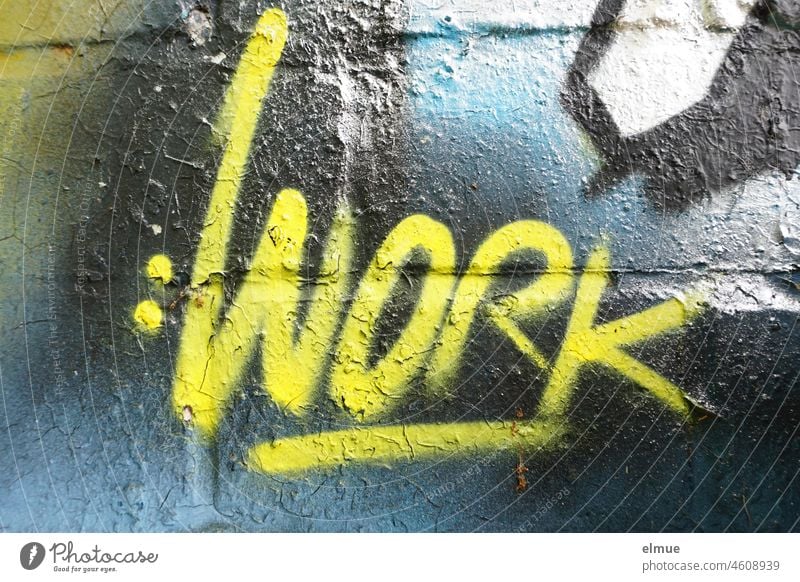 WORK is sprayed in yellow color on the graffiti wall / graffito work Graffito labour Yellow Function act Graffiti Graffiti wall Facade Typography Street art