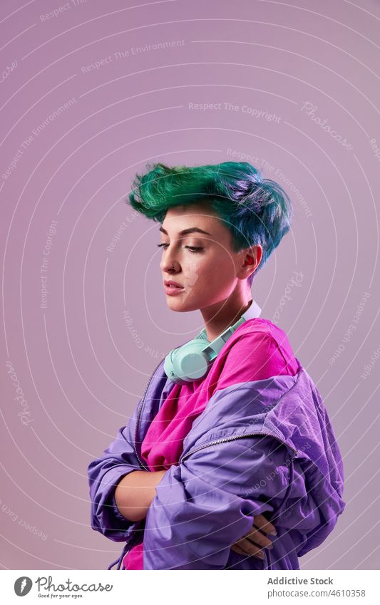 Serious informal woman with headphones meloman style millennial 80s fashion design retro studio green hair female model short hair appearance colorful lady