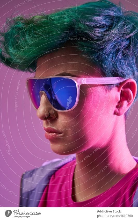 Crop of woman with dyed hair in sunglasses style millennial 80s fashion informal design studio green hair female model short hair appearance colorful hairstyle