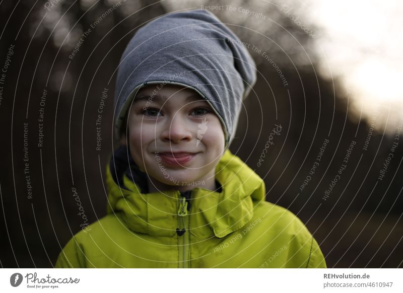 Boy with cap smiles Child Human being Boy (child) Infancy Environment Jacket Cap Smiling naturally Small Contentment Leisure and hobbies Forward