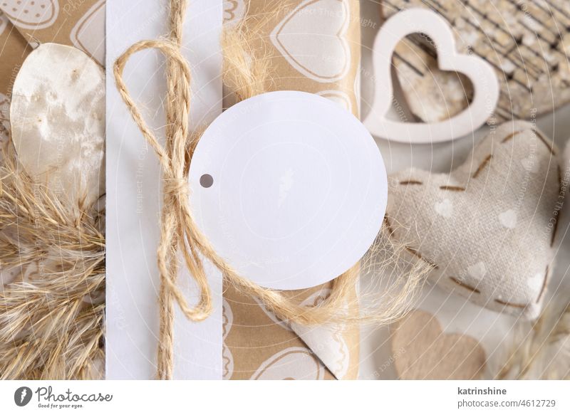 Valentines present with round blank gift tag and hearts close up, Rustic label Mockup mockup wrapped beige boho rustic love paper bohemian kraft spring summer
