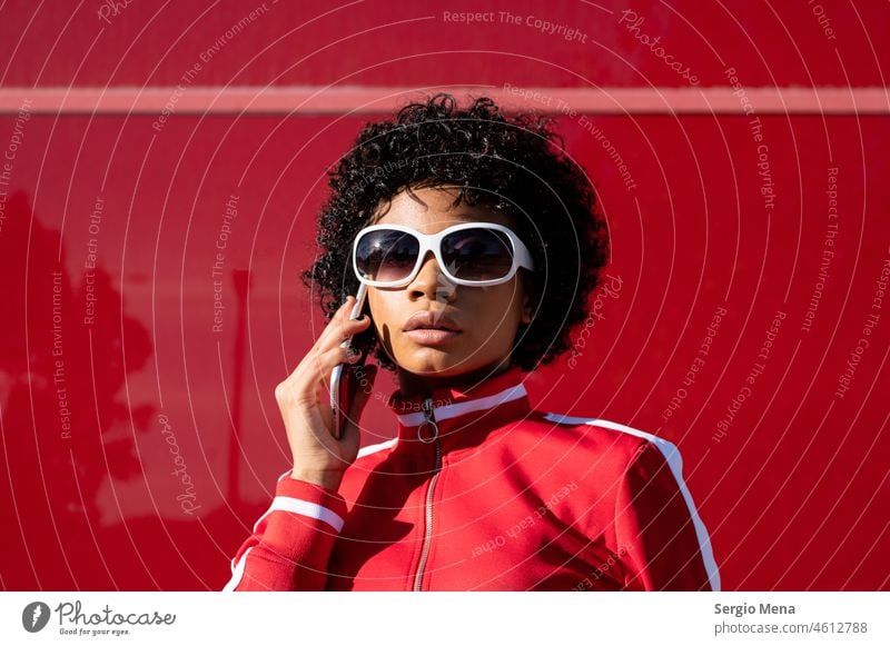 African American woman with short hair and sunglasses making a phone call afro american Short Hair young Young woman adult adult woman Clothing sport Sportswear