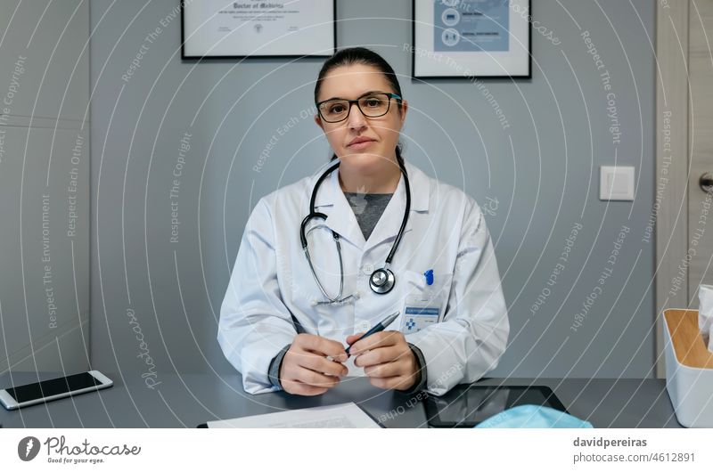 Female doctor looking at camera in her office woman portrait looking camera professional doctors office friendly medical hospital healthcare stethoscope clinic
