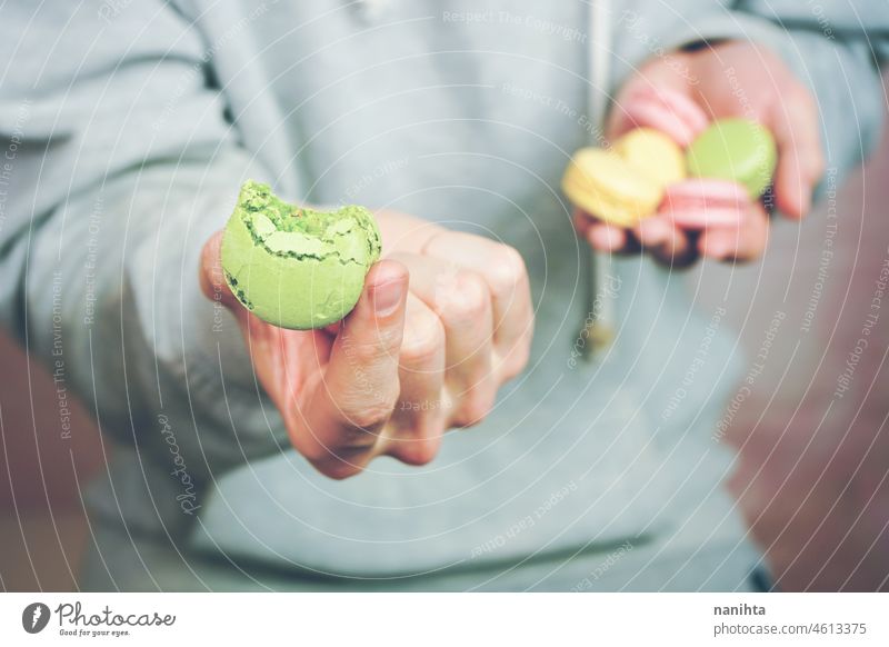 Man holding macaroins in his hands macarons macaroons temptation dessert sweet man food male delicious cuisine gourmet unhealthy sugar french variety mix many