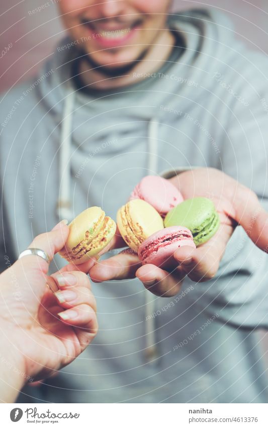Man holding macarons in his hands macaroons temptation dessert sweet man food male delicious cuisine gourmet unhealthy sugar french variety mix many stylish