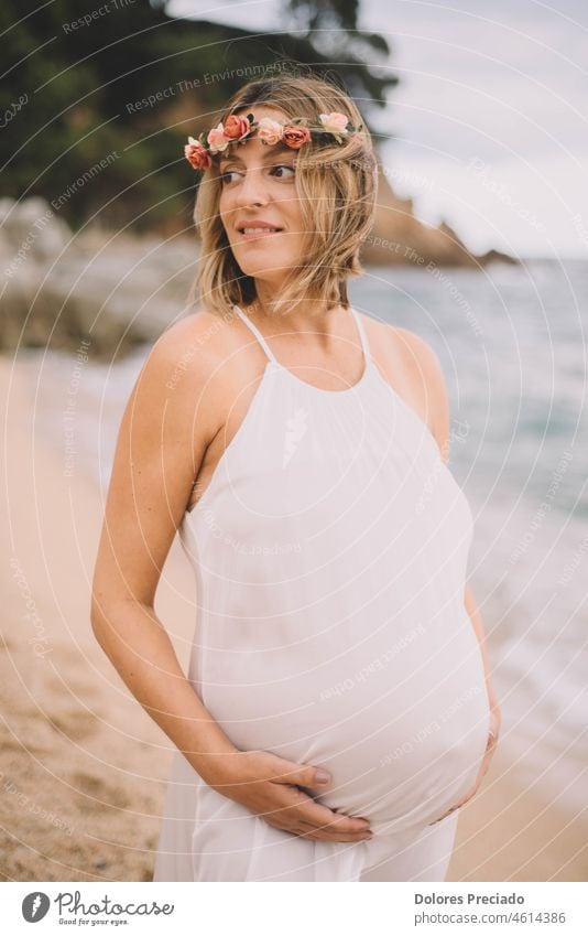 Photoshoot of a pregnant woman walking on the beach adult baby beautiful beauty belly birth care caucasian child cute expectant expecting family female fun girl