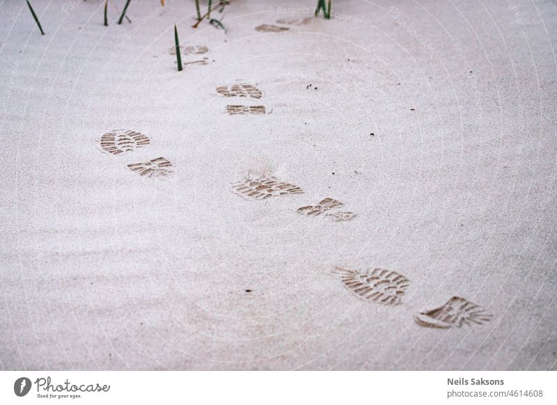 Footprints from shoes on Baltic sea beach sand adventure alone background boot coast coastline concept desert desolate detail dune foot footprint footstep