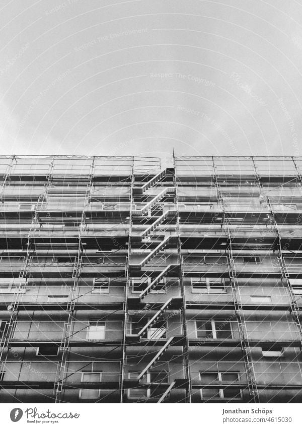 Residential house with scaffolding Deserted Town Contrast Exterior shot black-and-white out Street Apartment Building Scaffold construction Scaffolding