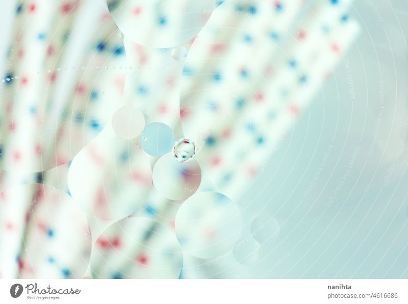 A beautiful and colorful macro of oil bubbles on water with blur of red and blue dots on white straws as background with vintage filter abstract wallpaper