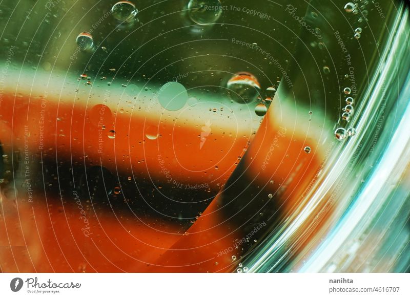 A beautiful and colorful macro of oil bubbles on water with a white, green and red stripe texture as background pattern with vintage filter abstract wallpaper