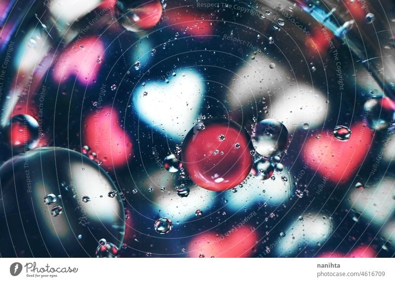 A beautiful and vibrant macro of oil bubbles on water with a blur of white and pink hearts pattern on black background abstract wallpaper resource bokeh amazing