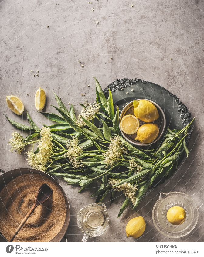 Ingredients  for homemade elder flower syrup: sugar, lemon and kitchen utensils on kitchen table.  Top view with copy space. Healthy lifestyle. ingredients