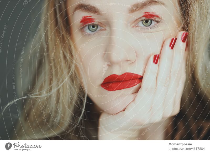 waiting Wait Red Wearing makeup Cosmetics Exasperated bored Boredom Blonde Woman Face of a woman Near red nails Nail polish Lipstick Eye shadow bright red