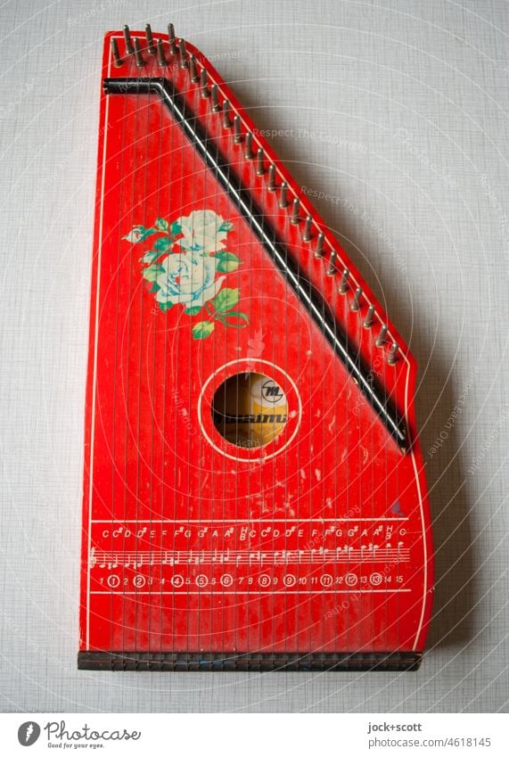 red harp decorated with scale and floral pattern Children's harp tool Musical instrument Detail Scale Varnished Wood Retro Tabletop Pattern Second-hand GDR