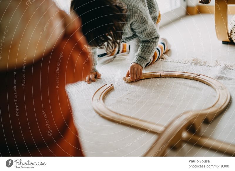 Child playing with wooden train track childhood Girl 3 - 8 years Playing Toys Train Track Happy Happiness Human being Joy Colour photo Infancy