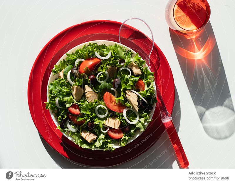 Tuna salad with onion and tomatoes served on red plates lettuce tuna olive oil serving mediterranean leaf recipe organic green nutrition spoon portion juice