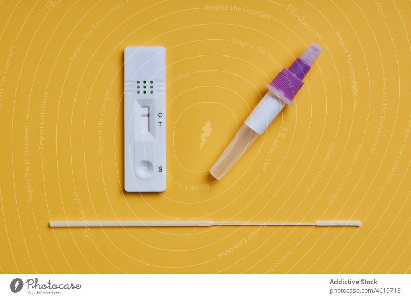 Yellow background with a covid rapid test extraction tube and a hisotope reagent coronavirus negative result healthy diagnosis health care clinic medical