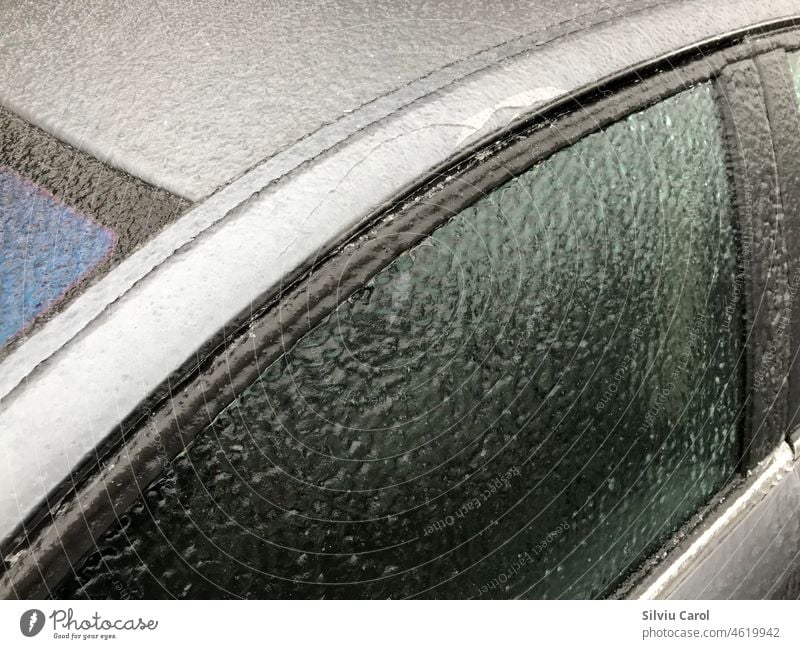 Ice-covered car window after icy rain closeup view of it winter automobile frost transport vehicle season ice blizzard city transportation weather climate cold