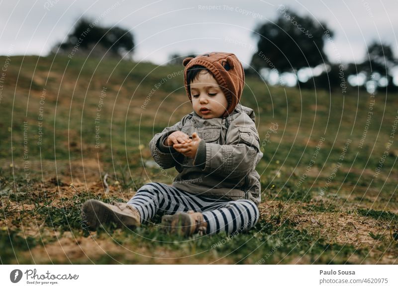 Child with hooded jacket playing outdoors childhood Boy (child) 1 - 3 years Caucasian real people Playing Winter Autumn Authentic Hooded (clothing)