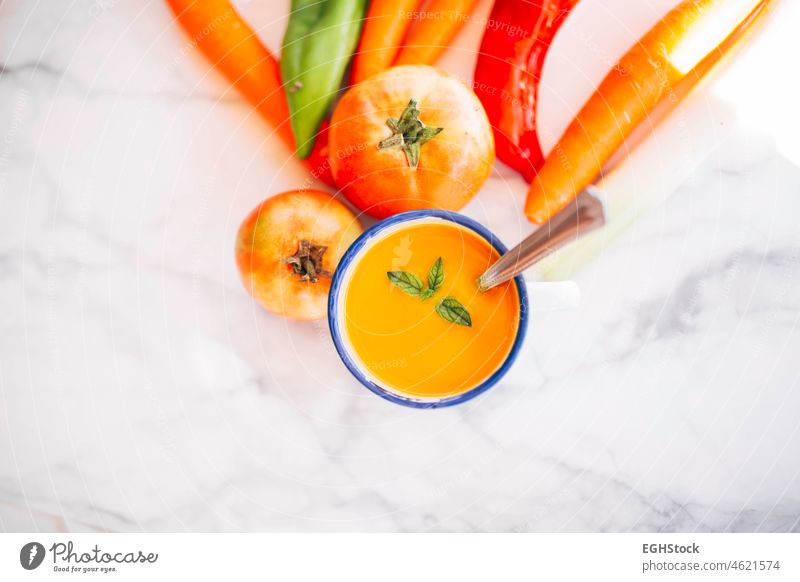 Vegan pumpkin cream in an enameled mug with vegetables, peppers and tomatoes soup food bowl meal autumn orange healthy squash rustic creamy nutrition smooth
