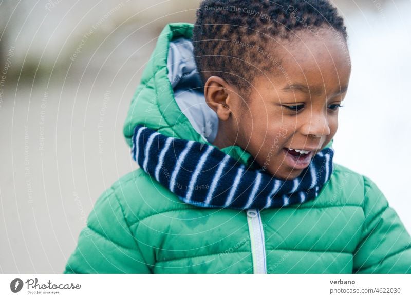 portrait of smiling african american child in winter clothes outdoors boy black kid smile teenager people face person happiness childhood one person hispanic
