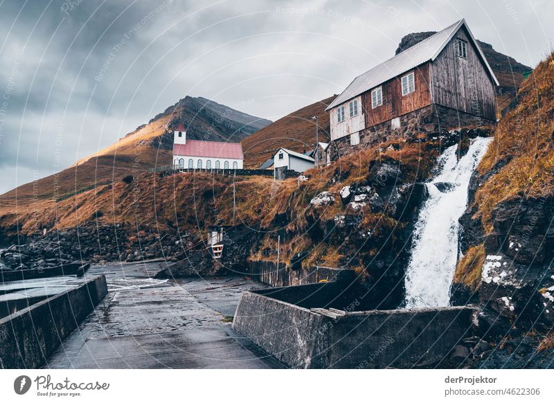 Faroe Islands: View of Kunoyar church from mini waterfall Holiday season Rural Landscape Picturesque highlands Cold Mountain Sunlight idyllically stunning Rock