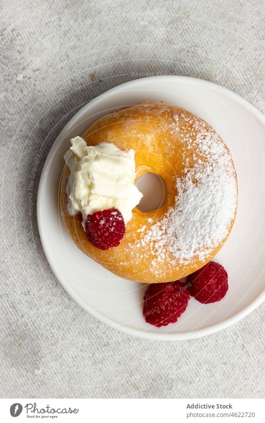 Sweet doughnut with ripe raspberries dessert sweet raspberry sugar pastry fried calorie treat tasty food serve sprinkle delicious table cheese appetizing plate