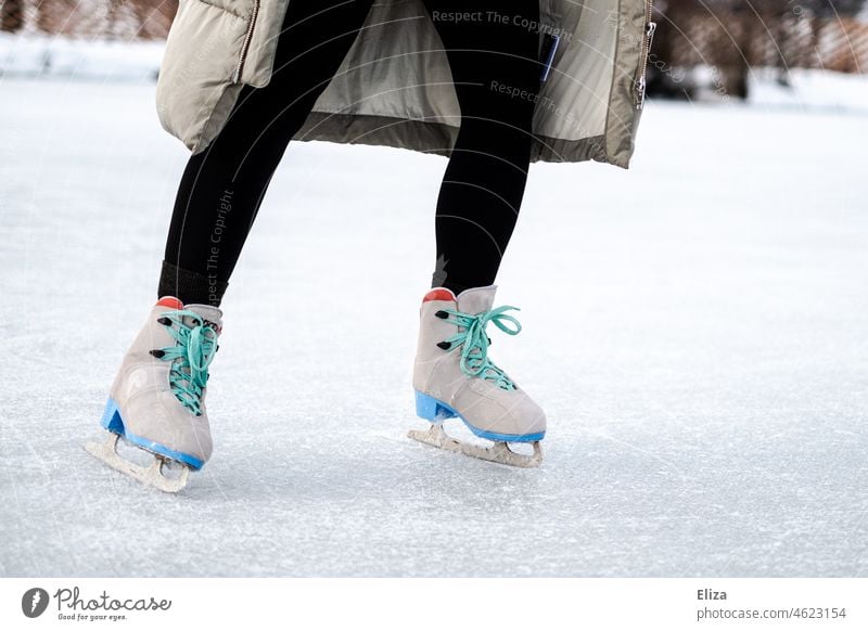 Woman skates on a skating rink ice rink Ice-skates Ice-skating Winter Winter sports Lake Leisure and hobbies Legs Frozen surface winter Human being Sports