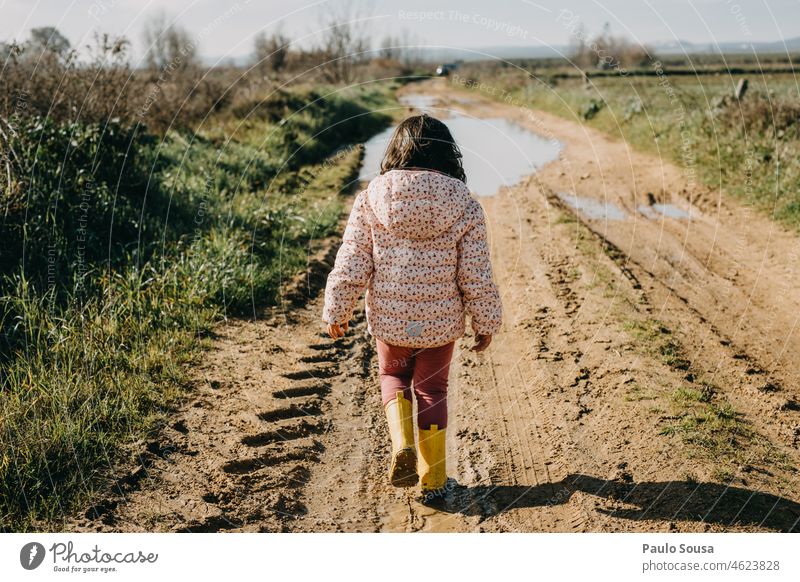 Rear view girl walking on dirty road Child childhood Girl 3 - 8 years Infancy Exterior shot Colour photo Human being Dirty Childhood memory 1 Nature Happiness