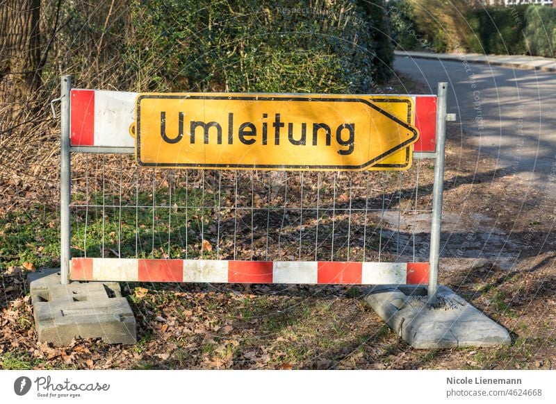 sign on road with german text umleitung, in english diversion construction traffic symbol germany street travel arrow white highway color detour isolated yellow