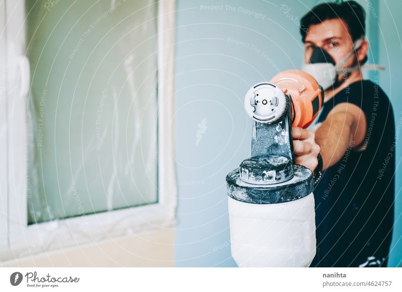 Young man doing a renovation at his home reform work job house paint room male working home improvement move removal relocation hard work work at home leisure