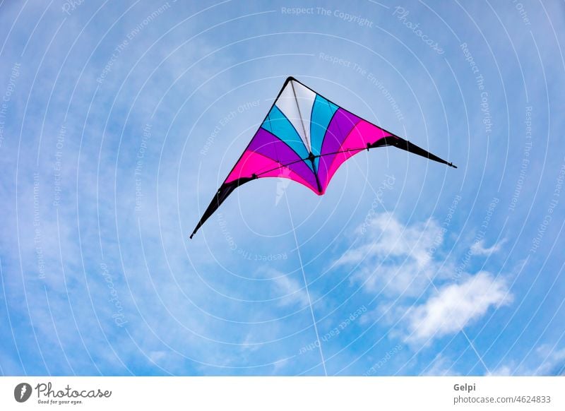 Colorful kite flying in the sky wind summer freedom air fun play blue string tail high toy leisure game background color beautiful white cloud colorful