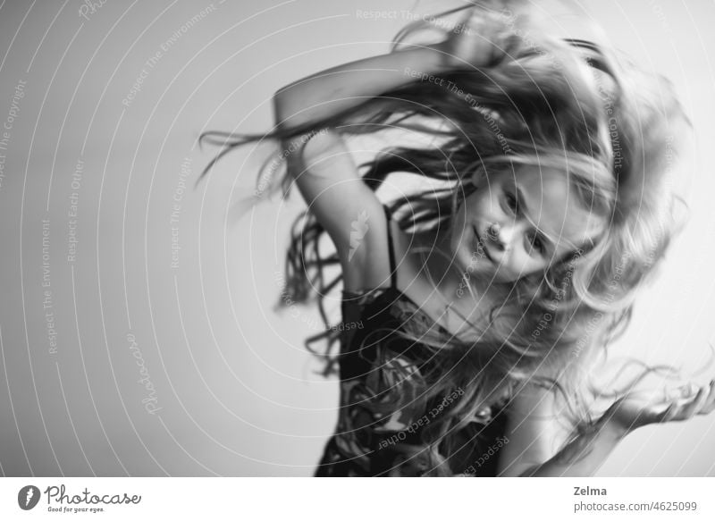 Portrait of a little girl with long healthy hair in motion child Black White Black & white photo Motion blur Dance dancing Studio shot teenager People jump
