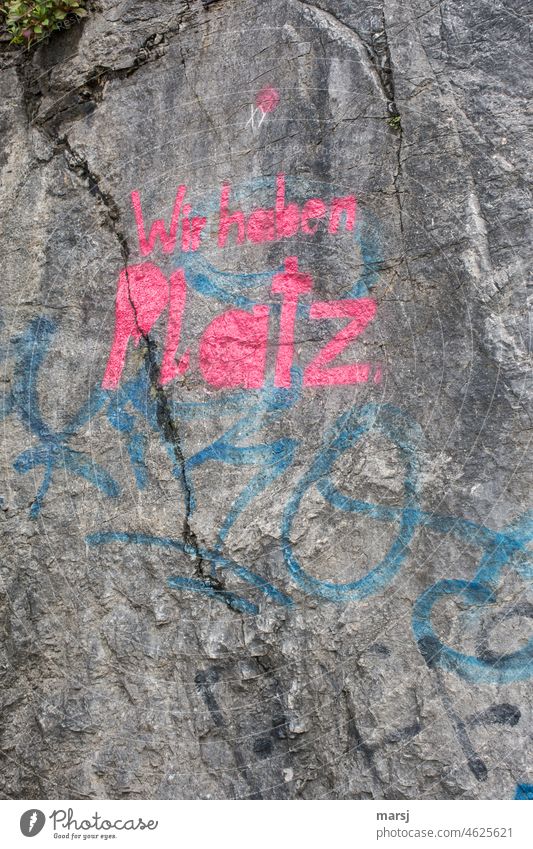 We have space. Dispute. Red lettering on rocks. Refugee issue. Characters Attachment Help Protection Exceptional Art smudged Creativity Memory writing