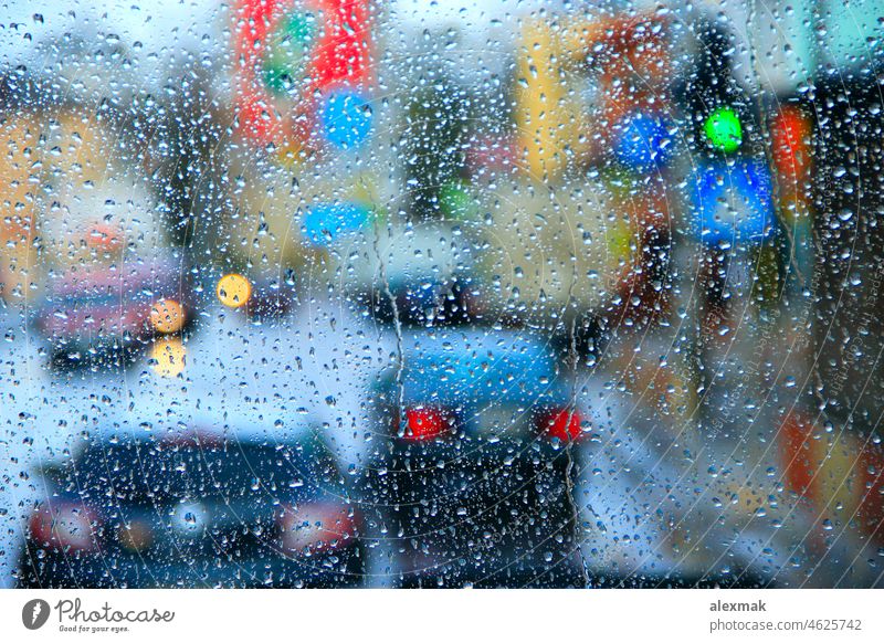 Rain outside window on city lights background. Water drops on glass when raining water wet droplet town downpour street dropping texture house nature road
