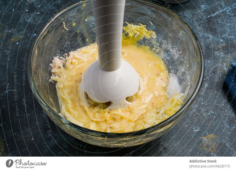 Hand blender mixing ingredients for chaffles dessert sweet waffle batter raw homemade food culinary recipe tasty delicious yummy cheese hand appetizing table
