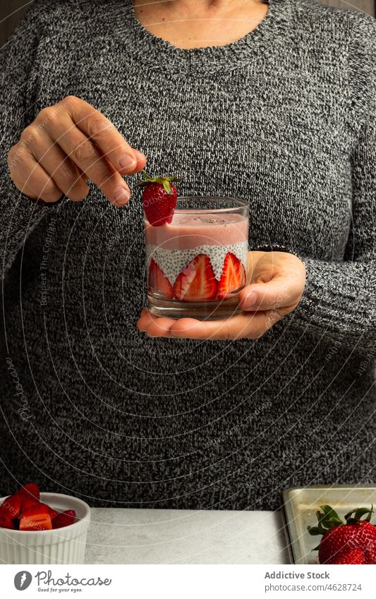 Female with glass of chia seed pudding with strawberry breakfast healthy dessert woman healthy food ingredient super food fresh yummy eat morning vitamin