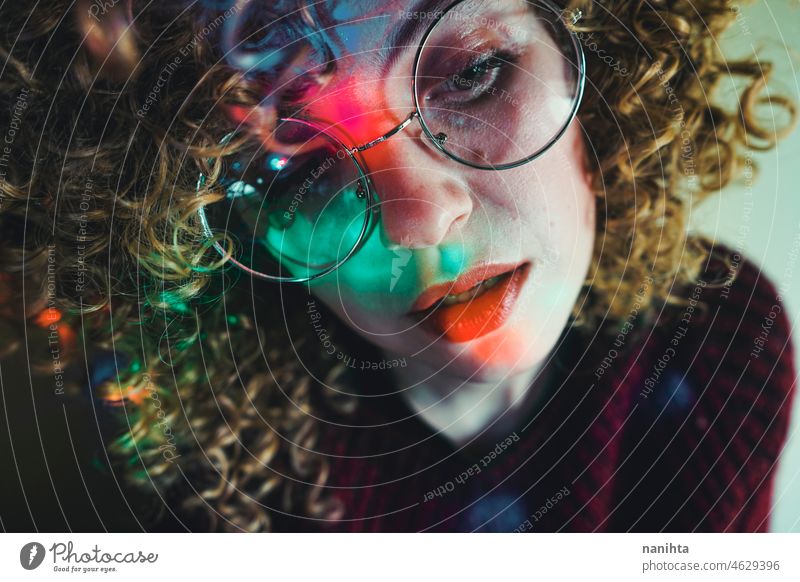 Young woman portrait illuminated by psychedelic lights retro neon party curly hair night pub alone lonely face proyector artistic creative neon lights