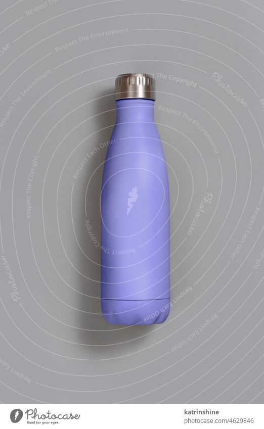 Light purple reusable insulated bottle on grey background very peri light purple lavender mockup ecologic water steel thermo aluminum blank close up concept