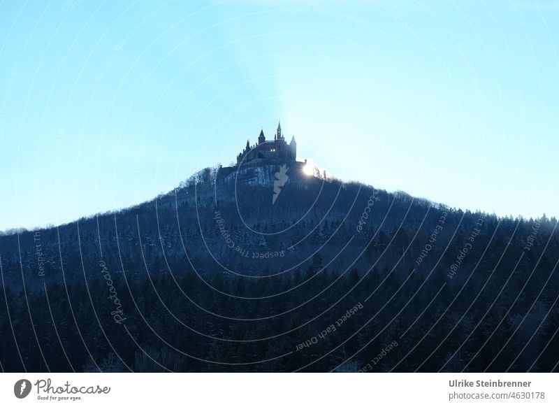 Winter morning sun rises behind Hohenzollern Castle Sunrise castle castle hill Sunbeam Forest Light Stammburg Prussia Mountain Cone mountain of witnesses