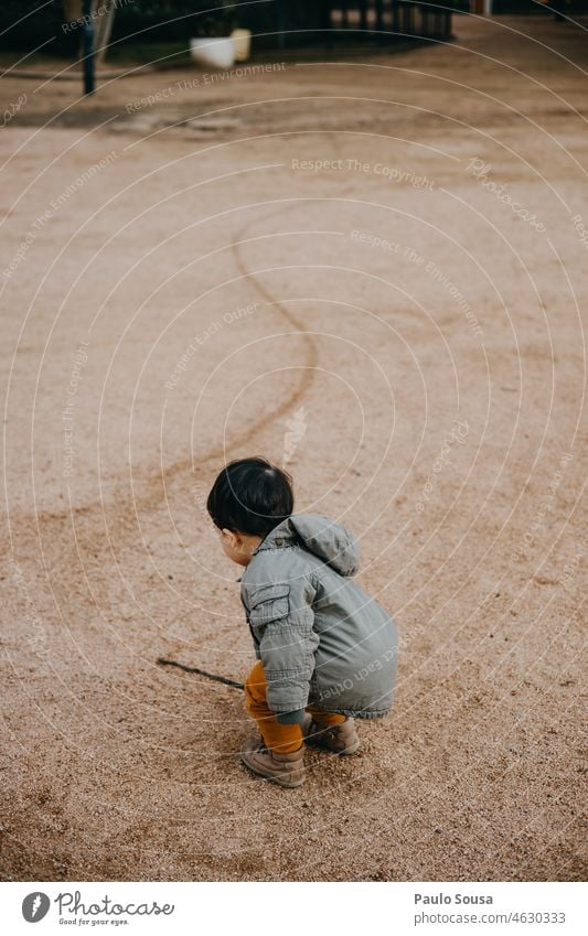 Child drawing on the soil childhood Rear view Boy (child) Authentic Caucasian 1 - 3 years Drawing Line Childhood memory Leisure and hobbies Lifestyle Infancy