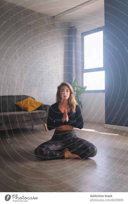 Woman meditating on yoga mat woman mental meditate posture breath practice eyes closed prayer hands gesture namaste hands together energy stress relief female