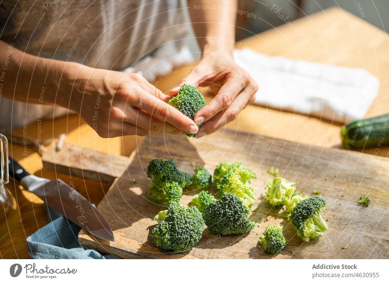 Unrecognizable cook preparing raw broccoli vegetable culinary recipe ingredient kitchen prepare vitamin chef food product gastronomy home process cutting board