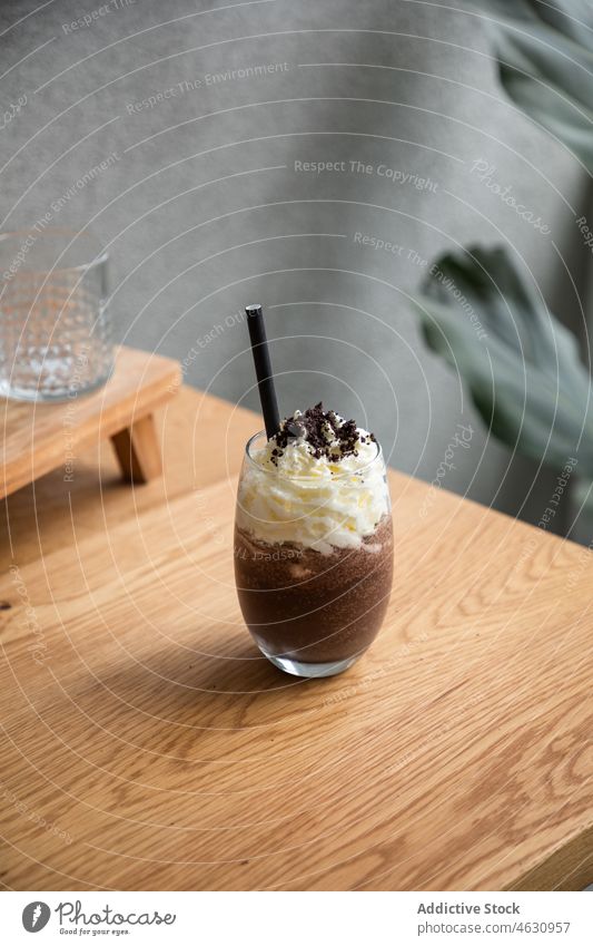 Frappe with whipped cream on table coffee frappe chocolate caffeine beverage drink refreshment sweet cold jar straw glass home tasty morning apartment