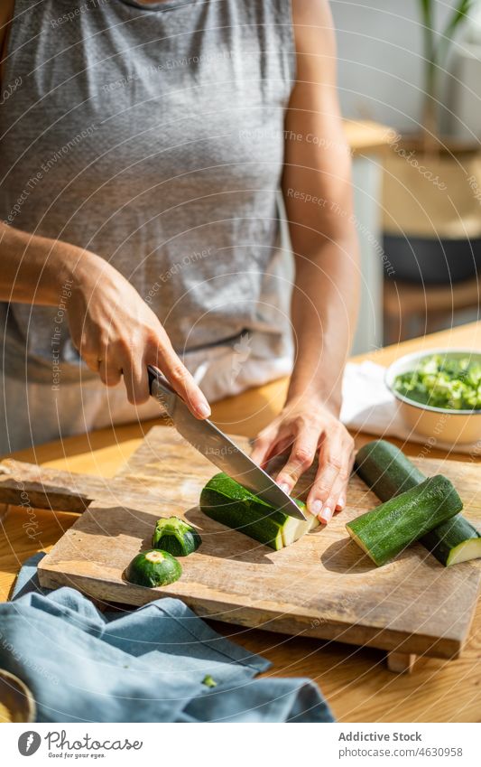 Unrecognizable woman cutting cucumber in kitchen vegetable cook culinary cuisine ingredient recipe prepare chef food product gastronomy home process