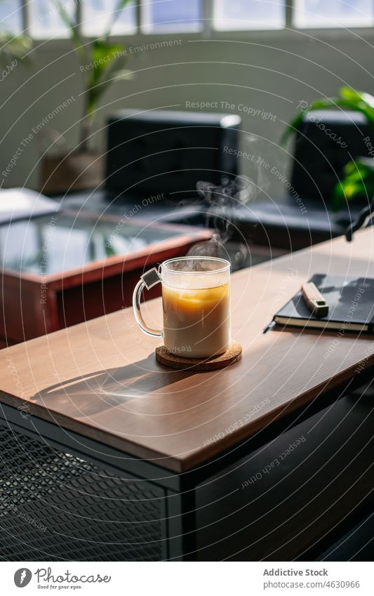 Cup of tea with milk hot drink beverage refreshment home counter room sunlight tasty shiny morning apartment transparent bright sunshine fragrant cup glass