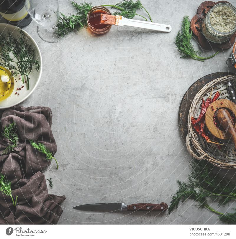 Food background with kitchen utensils and ingredients for meat marinade food background grey concrete table dill oil mortar pestle tablecloth salt copy space