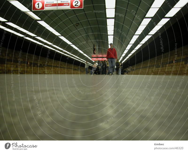 The boy in the red jacket Prague Underground London Underground Railroad tracks Lamp Vanishing point Going Movement Speed Tram Signs and labeling Floor covering